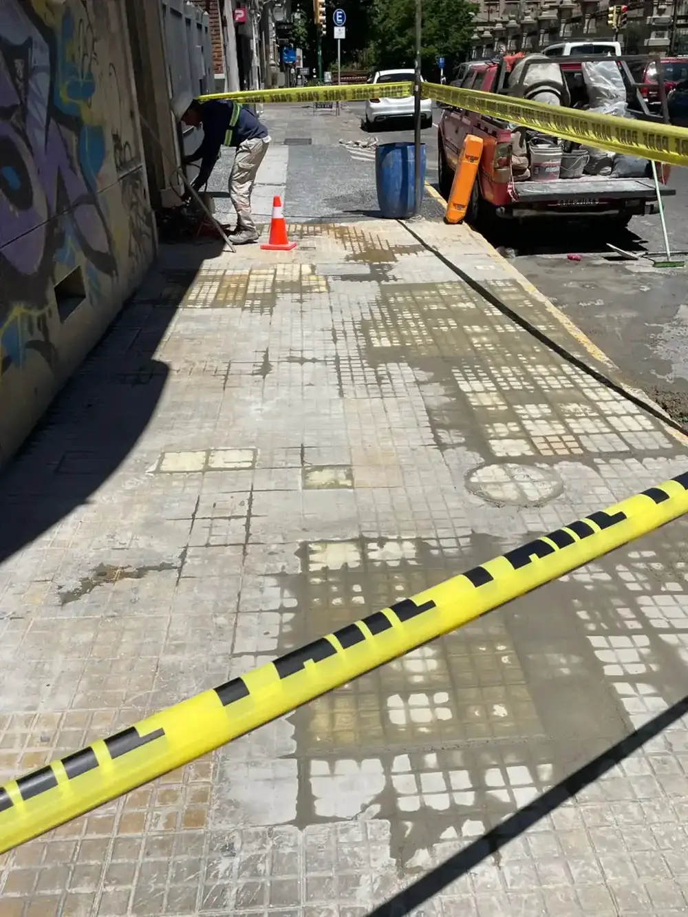 Vereda en reparación con señalización de seguridad en la calle